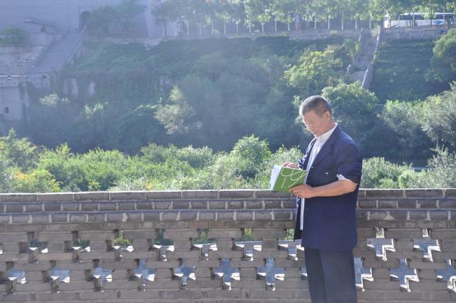Chinese wise man reading Thinque Funky on The Great Wall of China